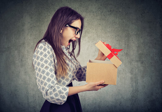 Woman opening a box and excited for pelvic floor store gift